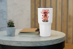 a white cup sitting on top of a table next to a plant