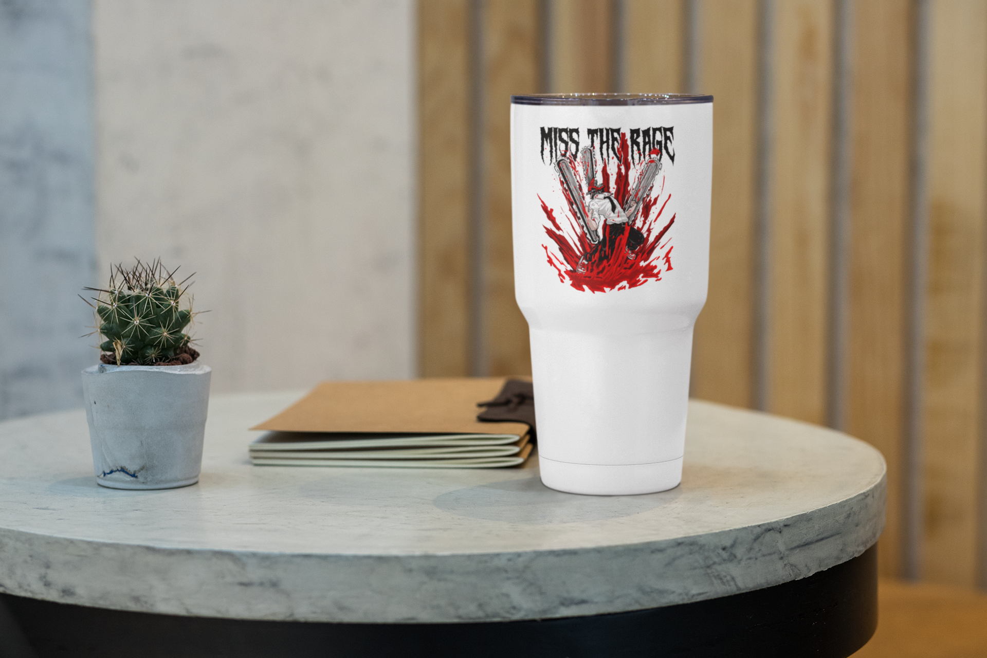 a white cup sitting on top of a table next to a plant
