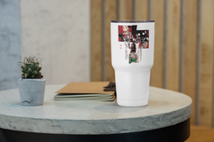 a white cup sitting on top of a table next to a plant