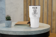 a white coffee cup sitting on top of a table